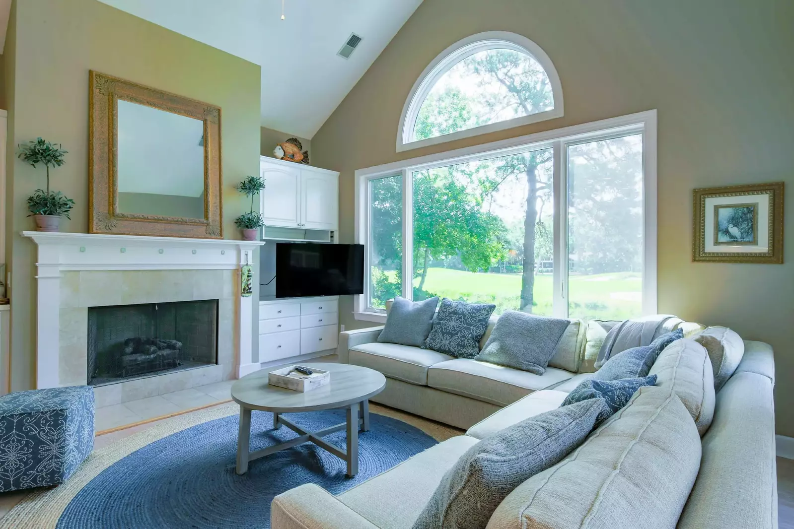 The family room features vaulted ceilings, golf course views and a spacious sectional sofa.
