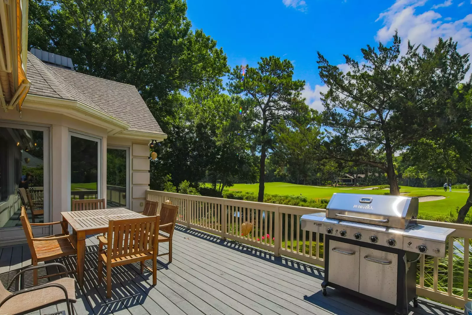 There is a gas BBQ grill on the back deck near the teak dining table & chairs.