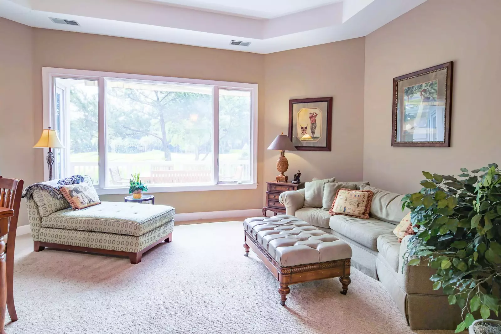 This living room features a comfortable seating area and views of the golf course.