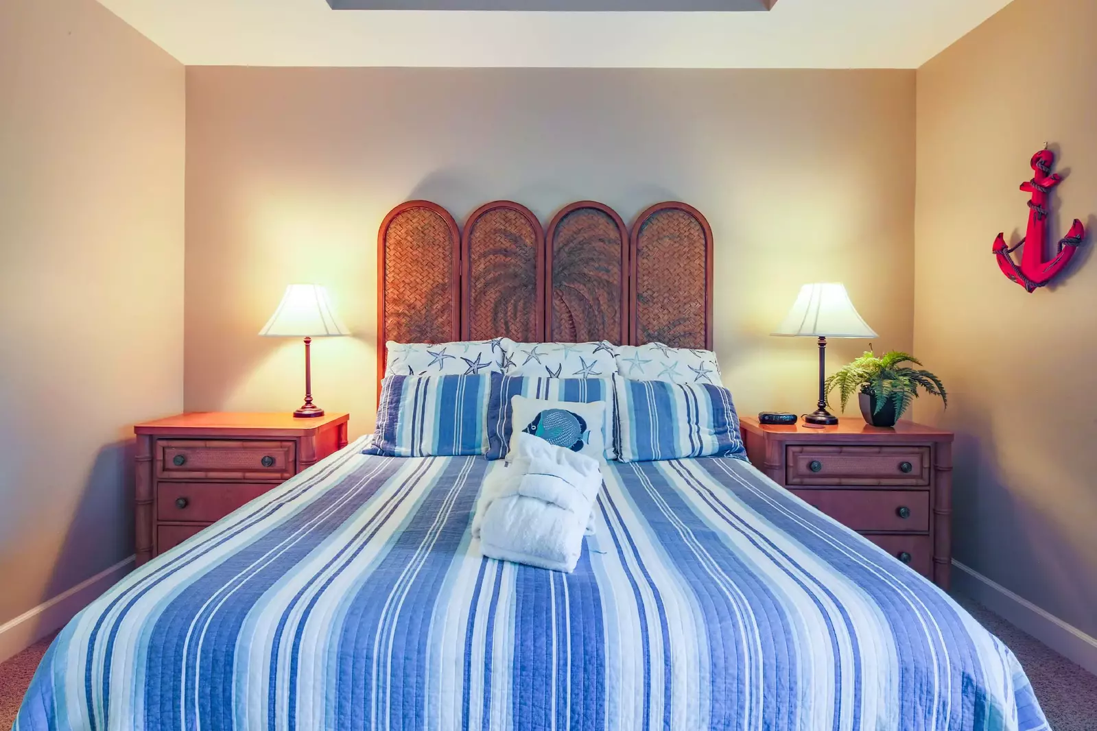 The master suite features a king bed and night stands with reading lamps.