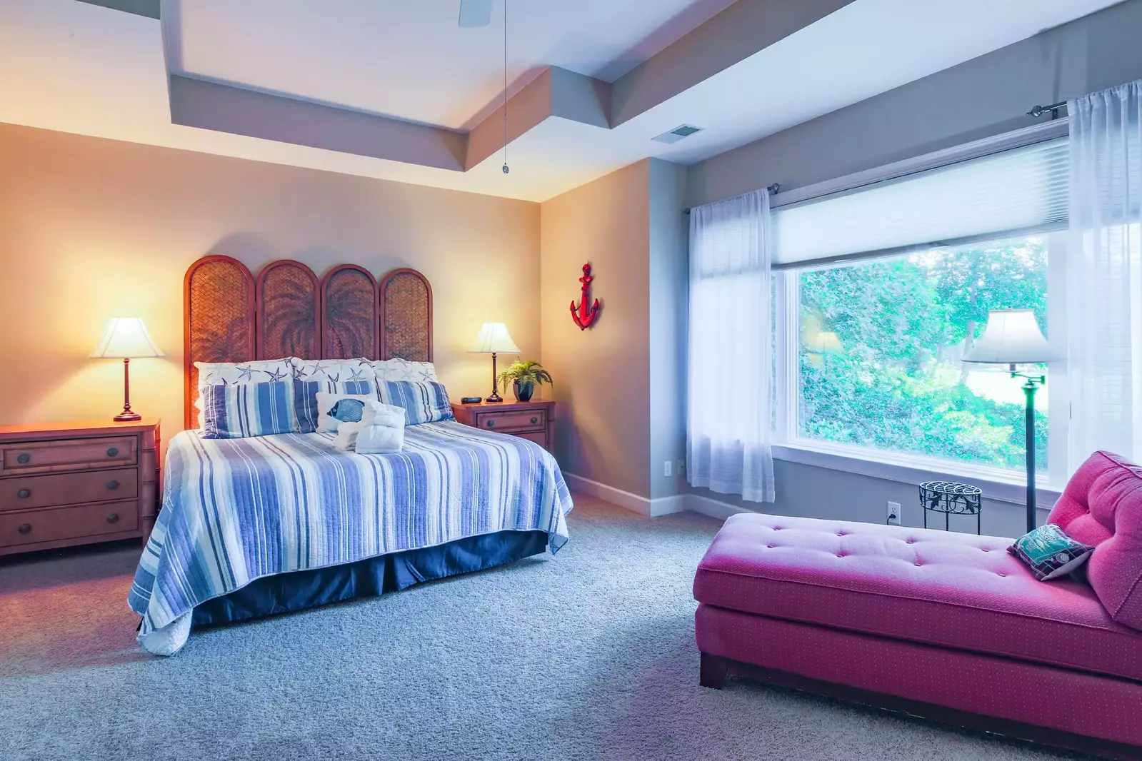 The master suite also features golf course views, a tray ceiing and a chaise lounge chair.