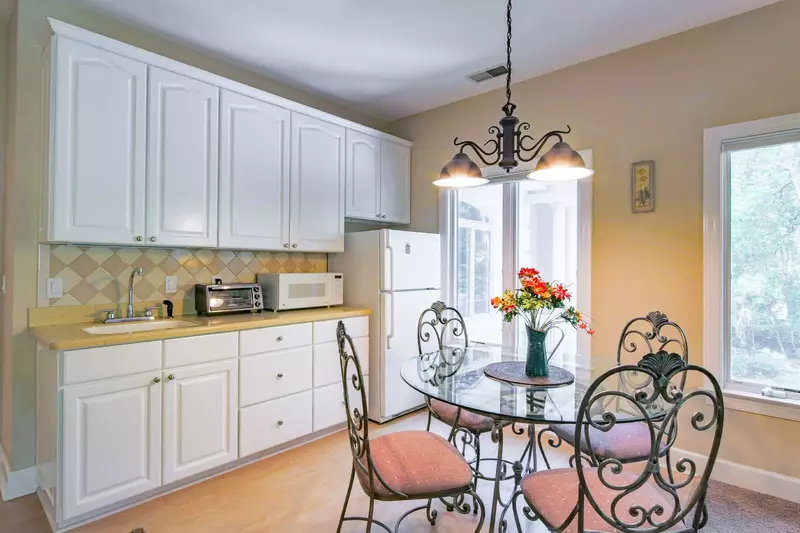 The second master suite also features this kitchenette and dining table & chairs.