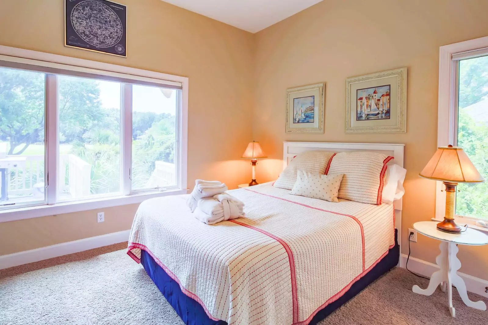 This bedroom features a queen bed and night stands with reading lamps.