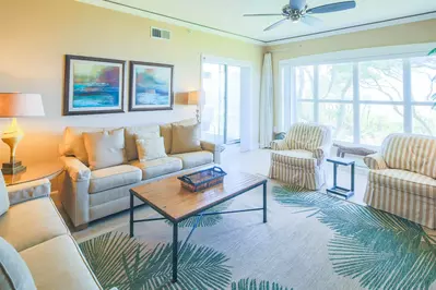 The living room features ocean views, a spacious seating area and lovely natural light.