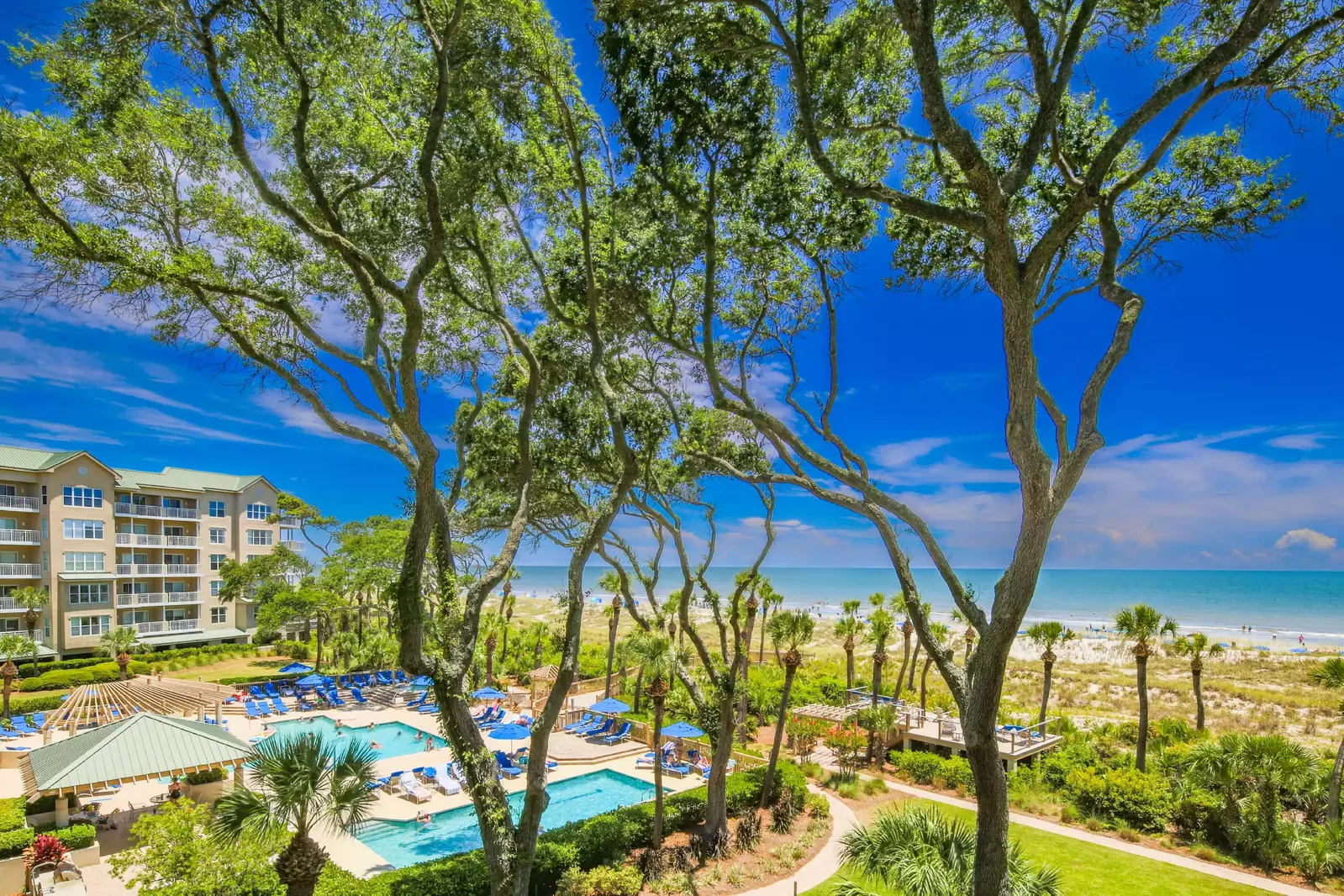 The Hampton Place community features terrific community pools with a sundeck and lounge chairs.