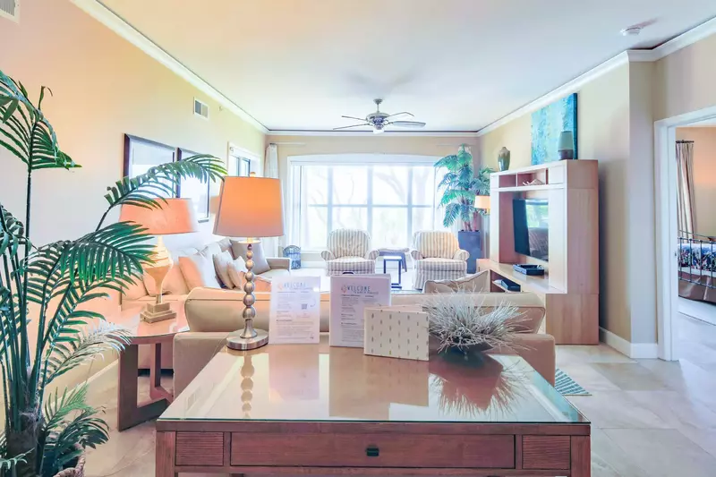 The living room features a spacious seating area and large screen TV.
