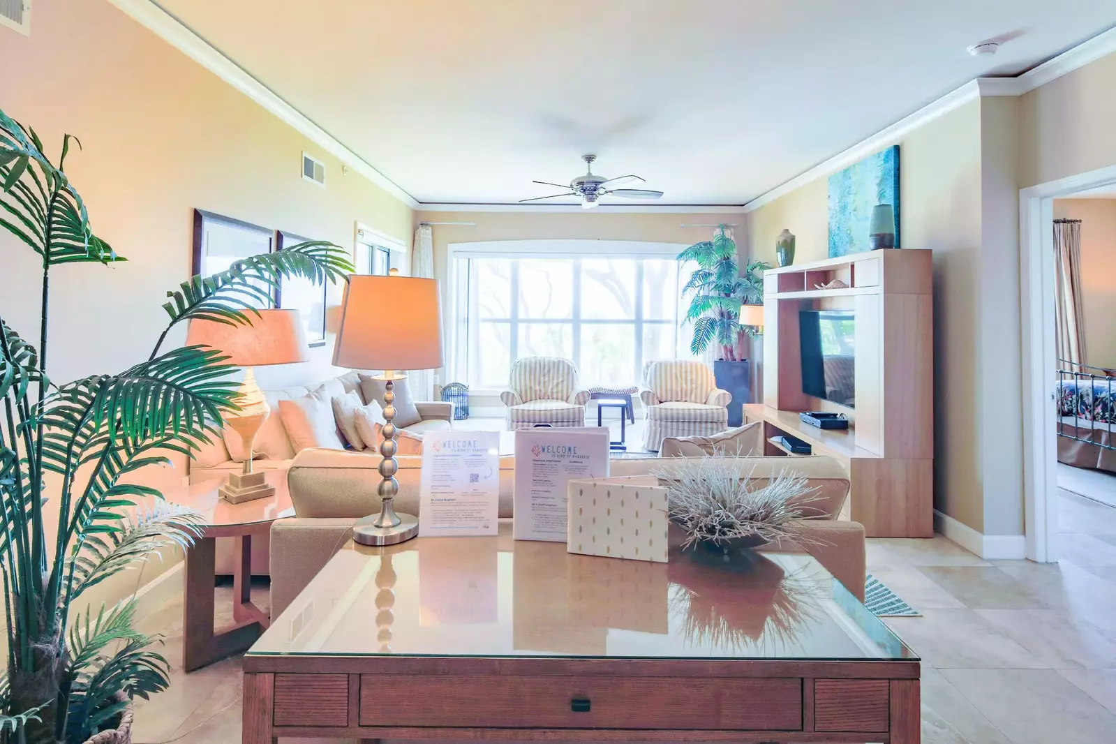 The living room features a spacious seating area and large screen TV.
