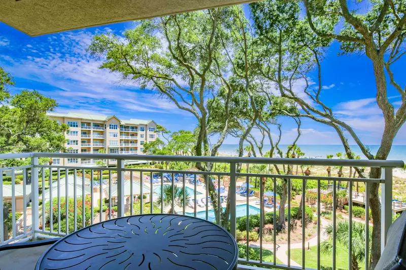 The private covered balcony is accessible from both the living room and guest suite.