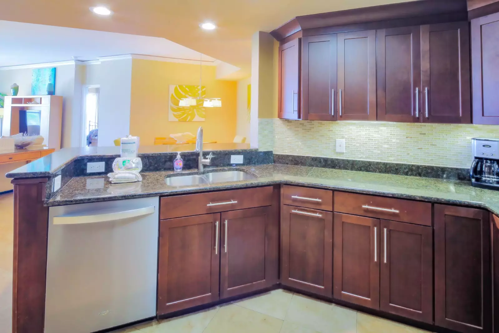 The kitchen features granite countertops, a tiled backsplash and stainless steel appliances.