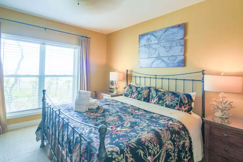 The master suite features a king bed and ocean views.
