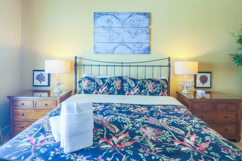 The master suite also features two nightstands with reading lamps.