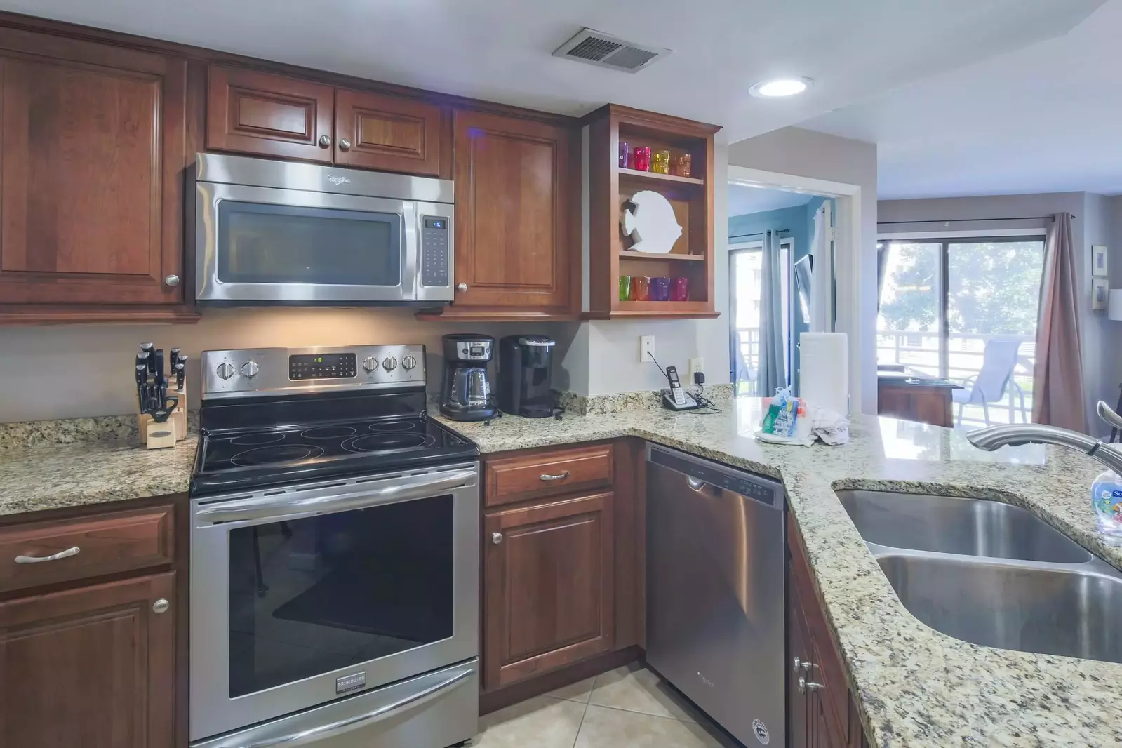 The kitchen features stainless steel appliances and granite countertops.