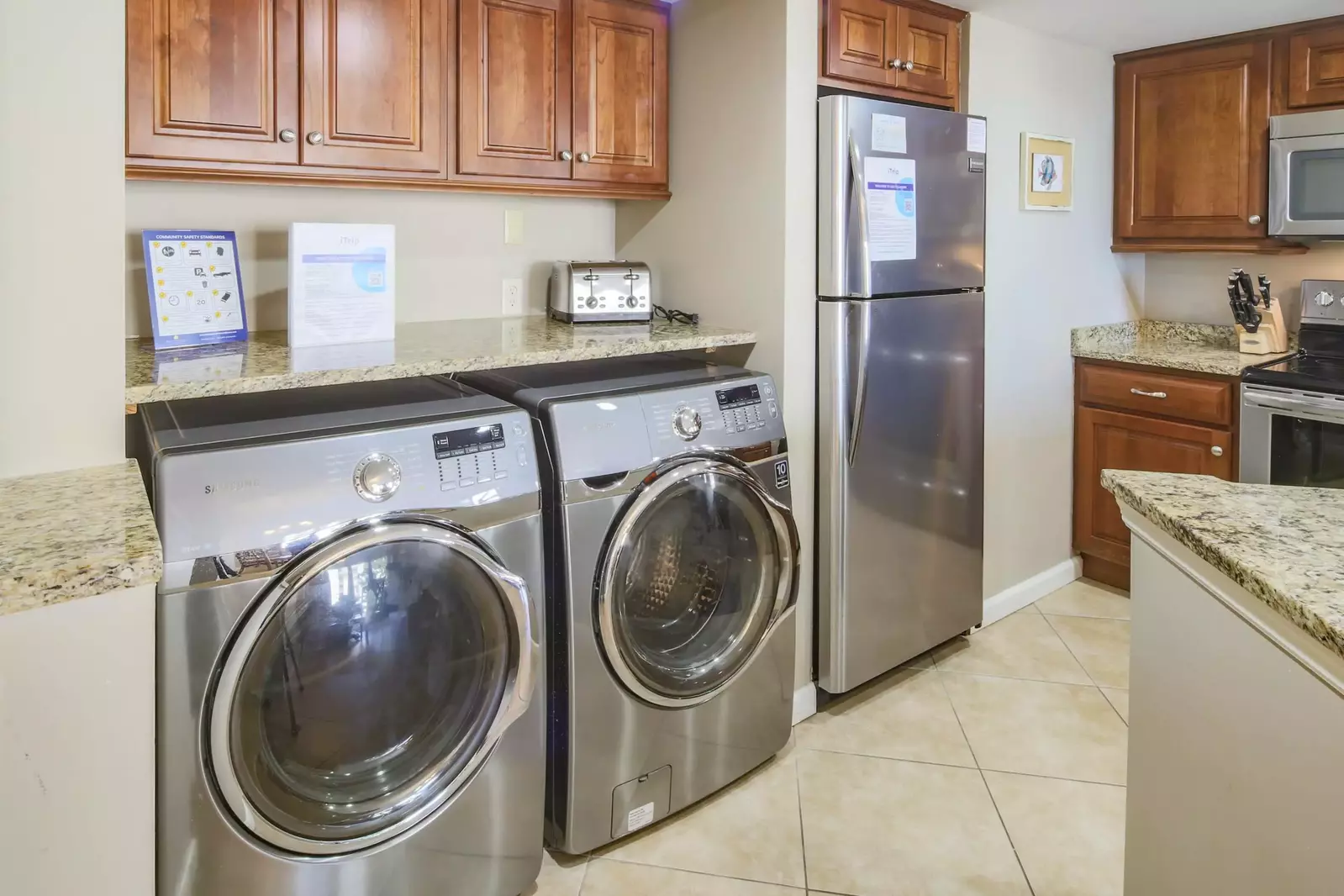 There is a full-sized washing machine and dryer located within the kitchen.