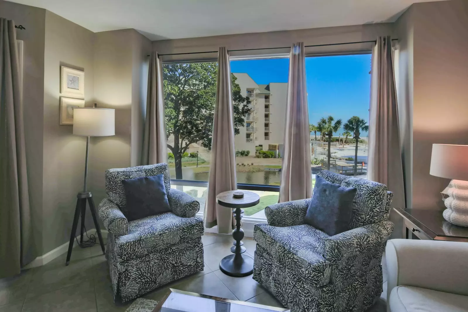 The living room also features views of the ocean, community pool and lagoon.