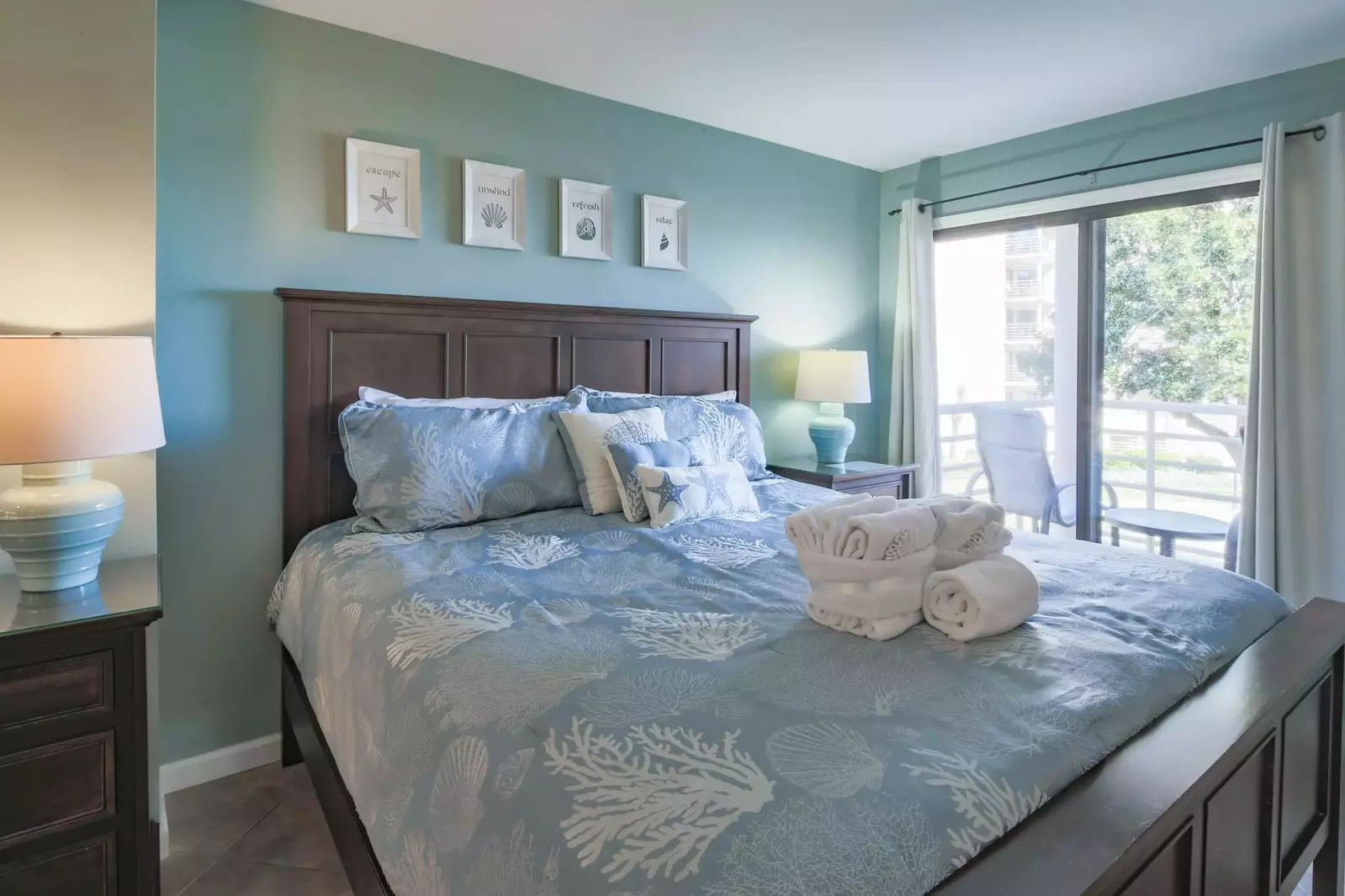 The master suite features a king bed and night stands with reading lamps.