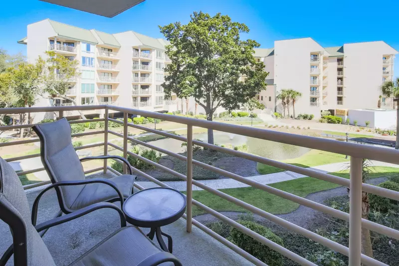 Step out onto the covered balcony to enjoy views of the Villarmare gardens, lagoon, community pool and ocean.