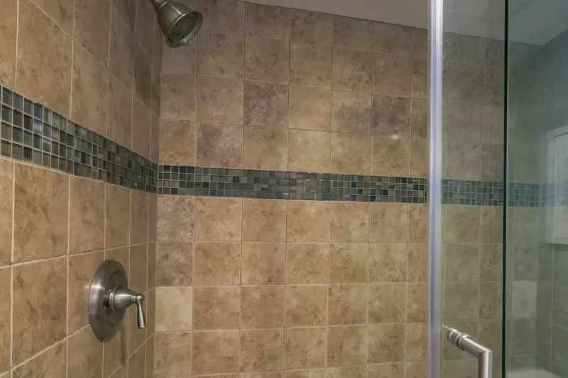 The master suite also has a tiled, walk-in shower.