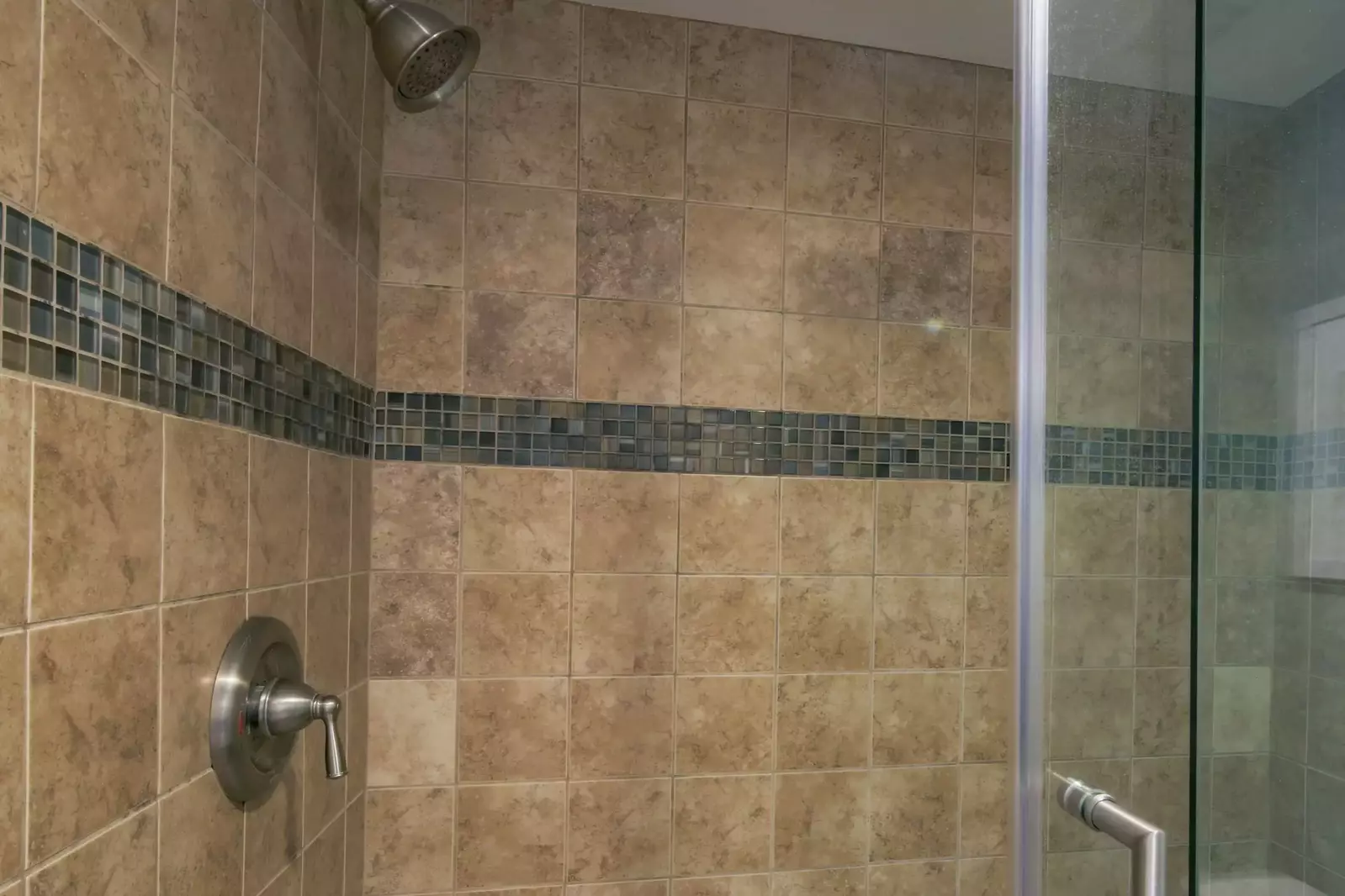 The master suite also has a tiled, walk-in shower.