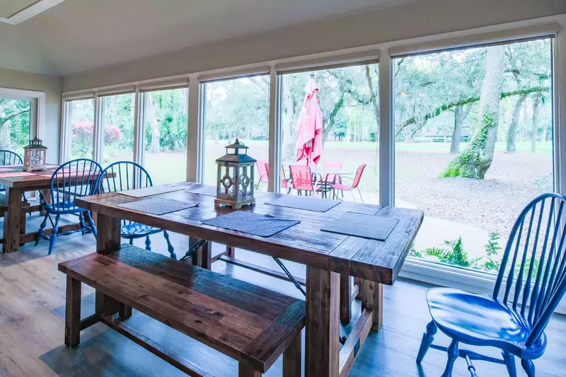 The wall-to-wall windows in the dining area look out onto the patio, backyard and golf course.