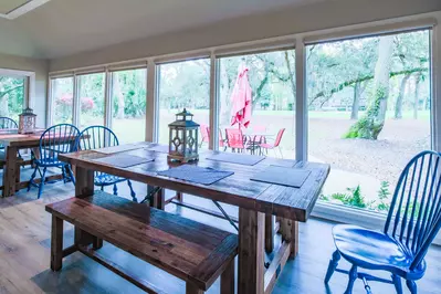 The wall-to-wall windows in the dining area look out onto the patio, backyard and golf course.