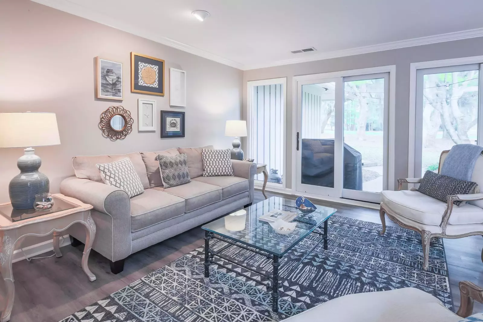 The living room has sliding door access to the back patio and gas grill.
