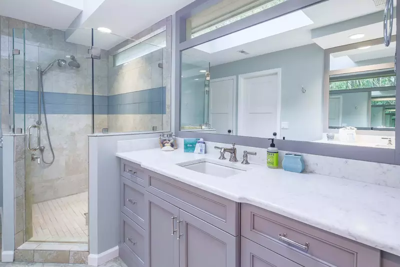 The en suite bathroom also has a beautifully tiled, walk-in shower with two shower heads.