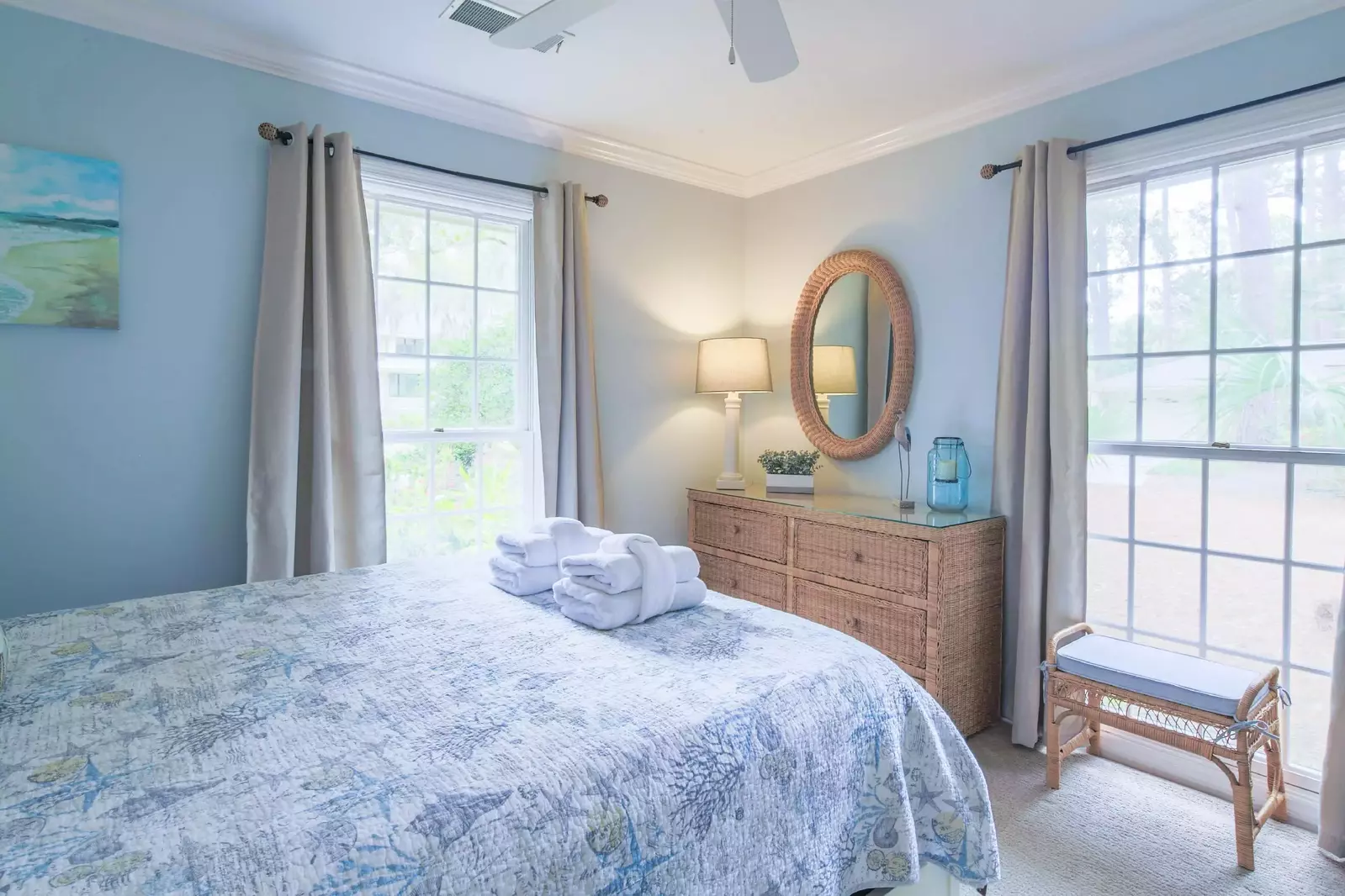 The queen guest bedroom also has a dresser, ceiling fan and bench.