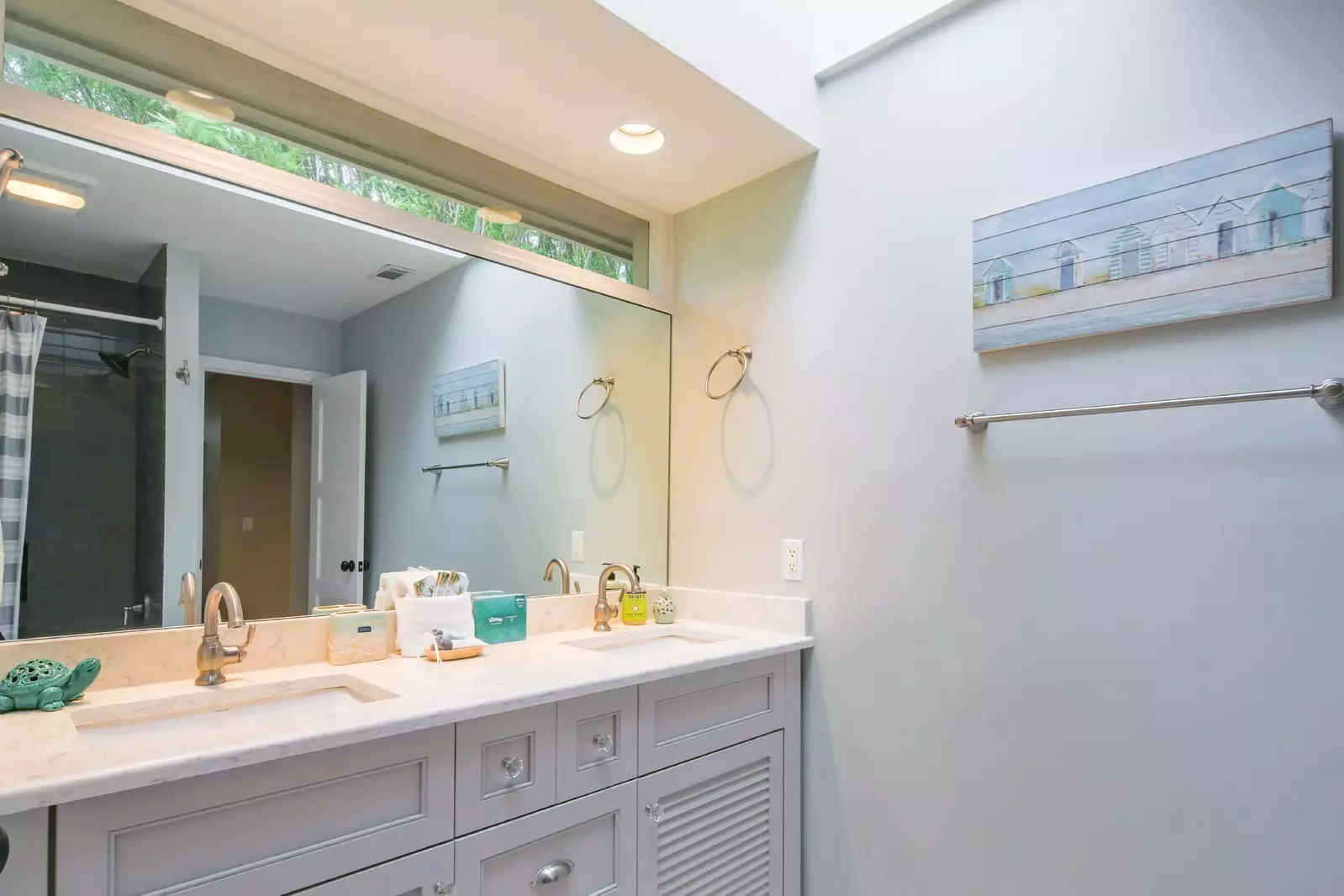 This hallway bathroom, with a dual sink vanity, is shared by the two guest bedrooms.