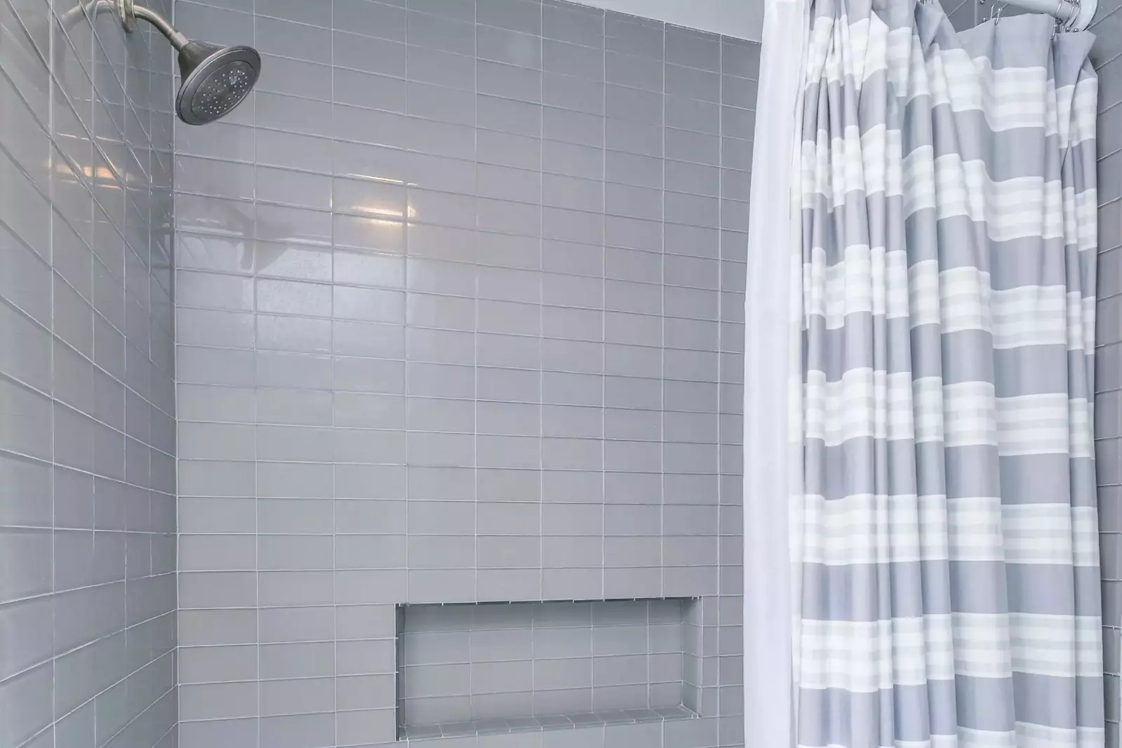 The hallway bathroom also has a tiled, shower/tub combo.