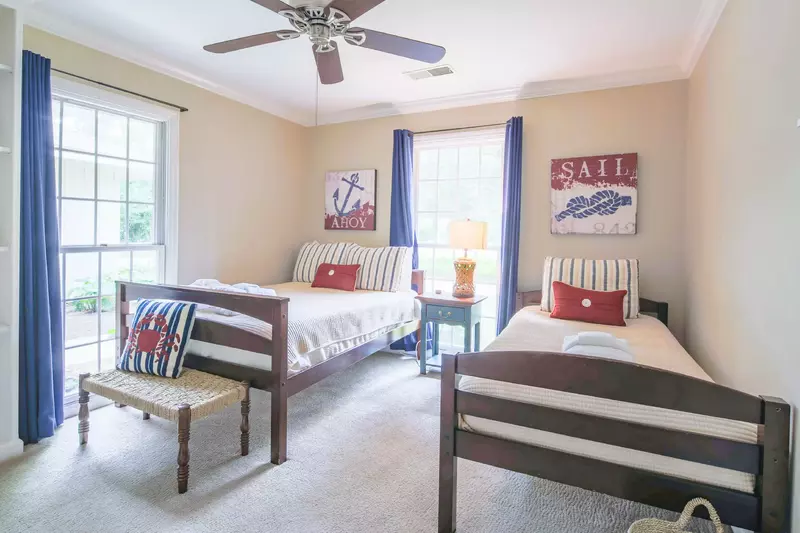 This guest bedroom features lovely natural light.
