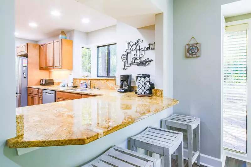 The well-stocked kitchen features granite countertops and stainless steel appliances.