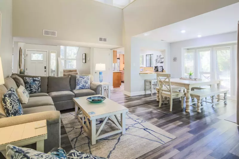 The entryway also connects to the stairwell, the kitchen and the hall to the lower level bedrooms.