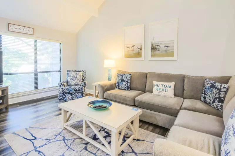There is a spacious sectional sofa and arm chair in the living room.