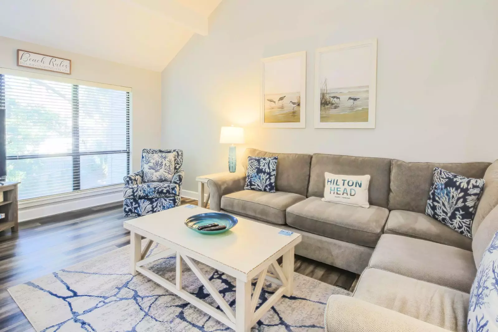 There is a spacious sectional sofa and arm chair in the living room.