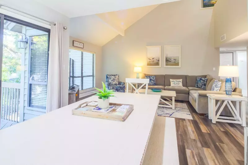 The living room flows into the dining area as well as the sliding glass door to the back deck.
