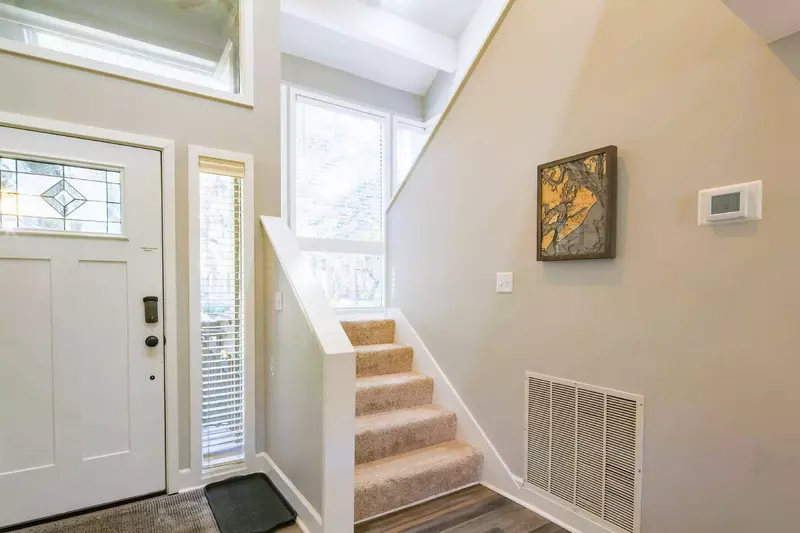 This stairway near the front door leads to the loft and the master suite.