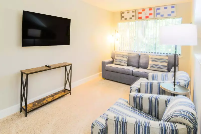 The loft features a queen sleeper sofa, seating area and a wall-mounted TV.