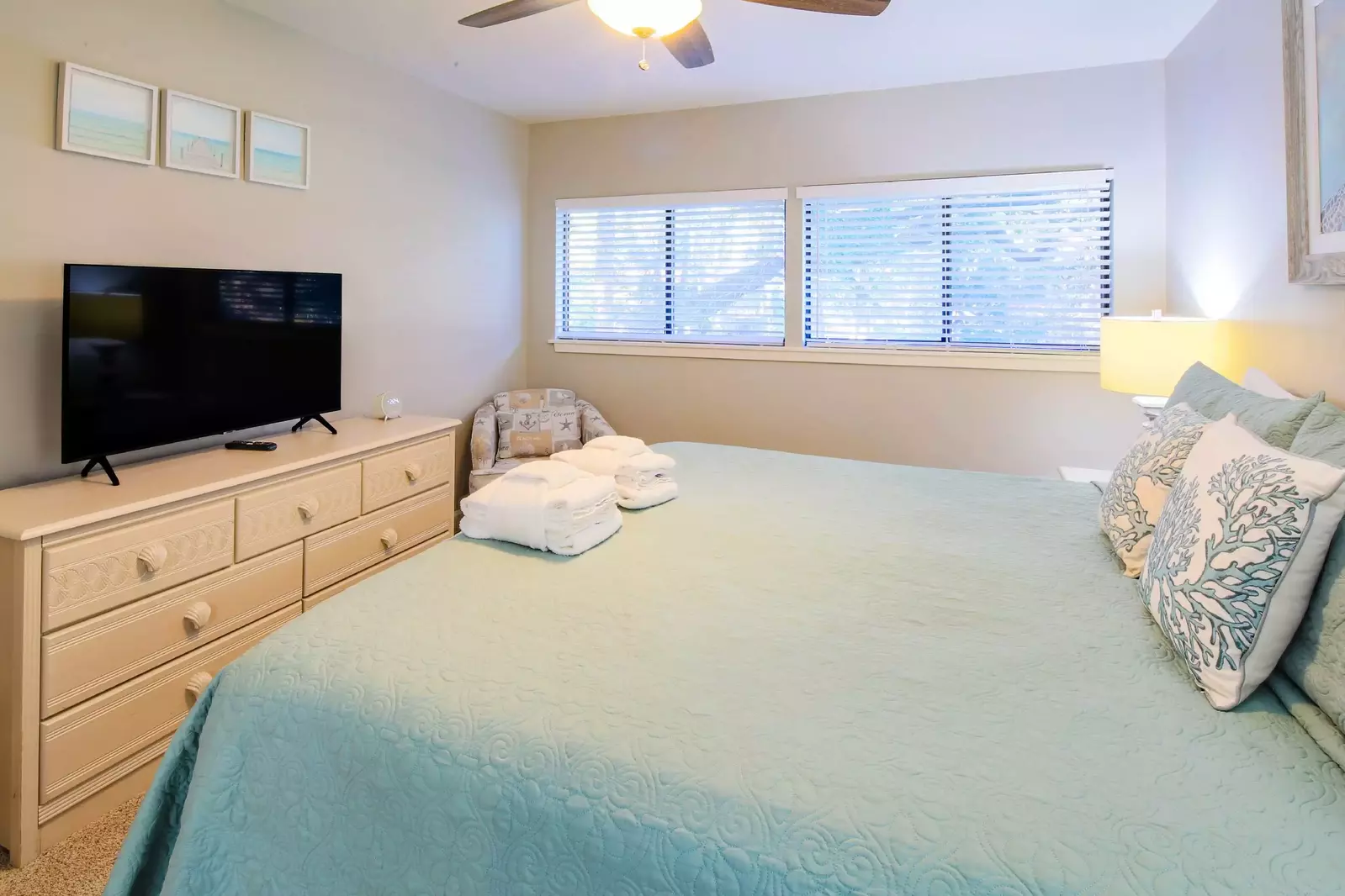 The master suite also features a dresser with a flat screen smart TV.