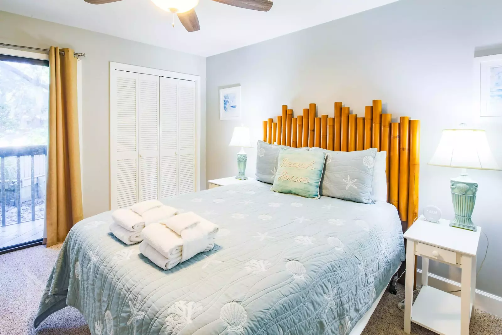 The queen suite features a queen bed, night stands with reading lamps and access to a private balcony.