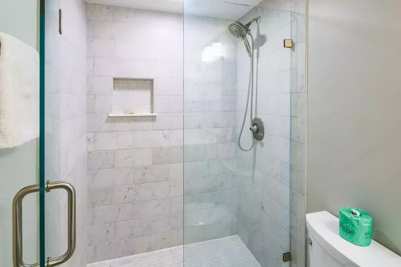 This bathroom features a beautifully tiled, walk-in shower.