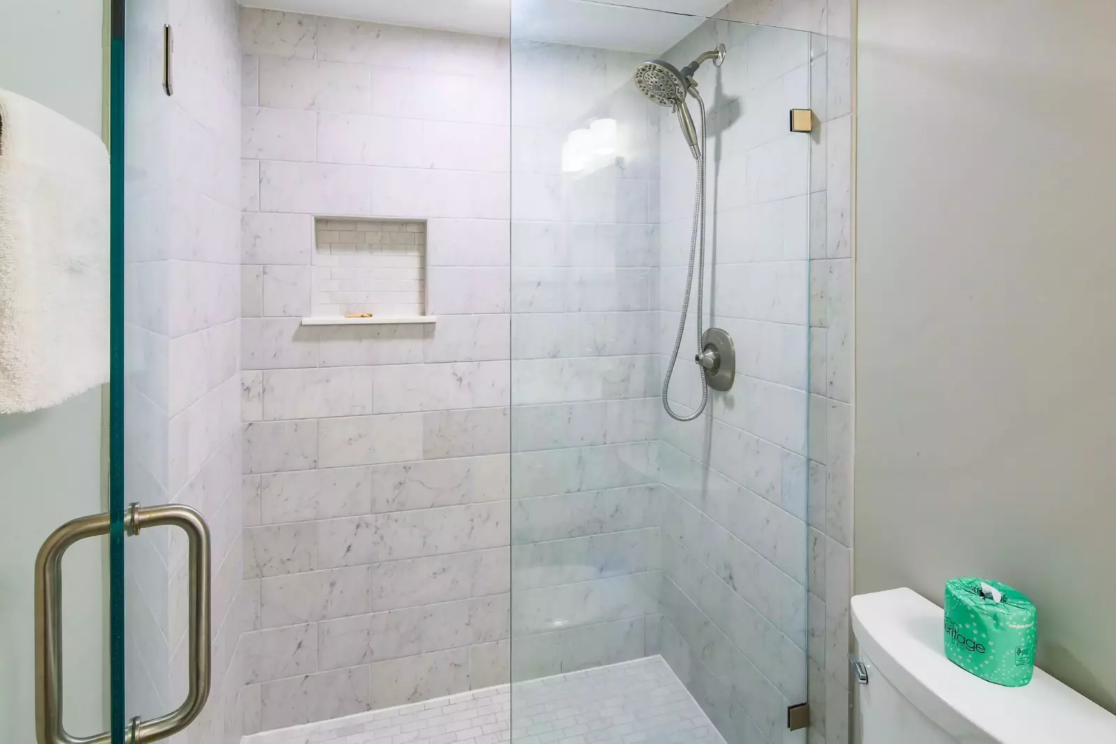 This bathroom features a beautifully tiled, walk-in shower.