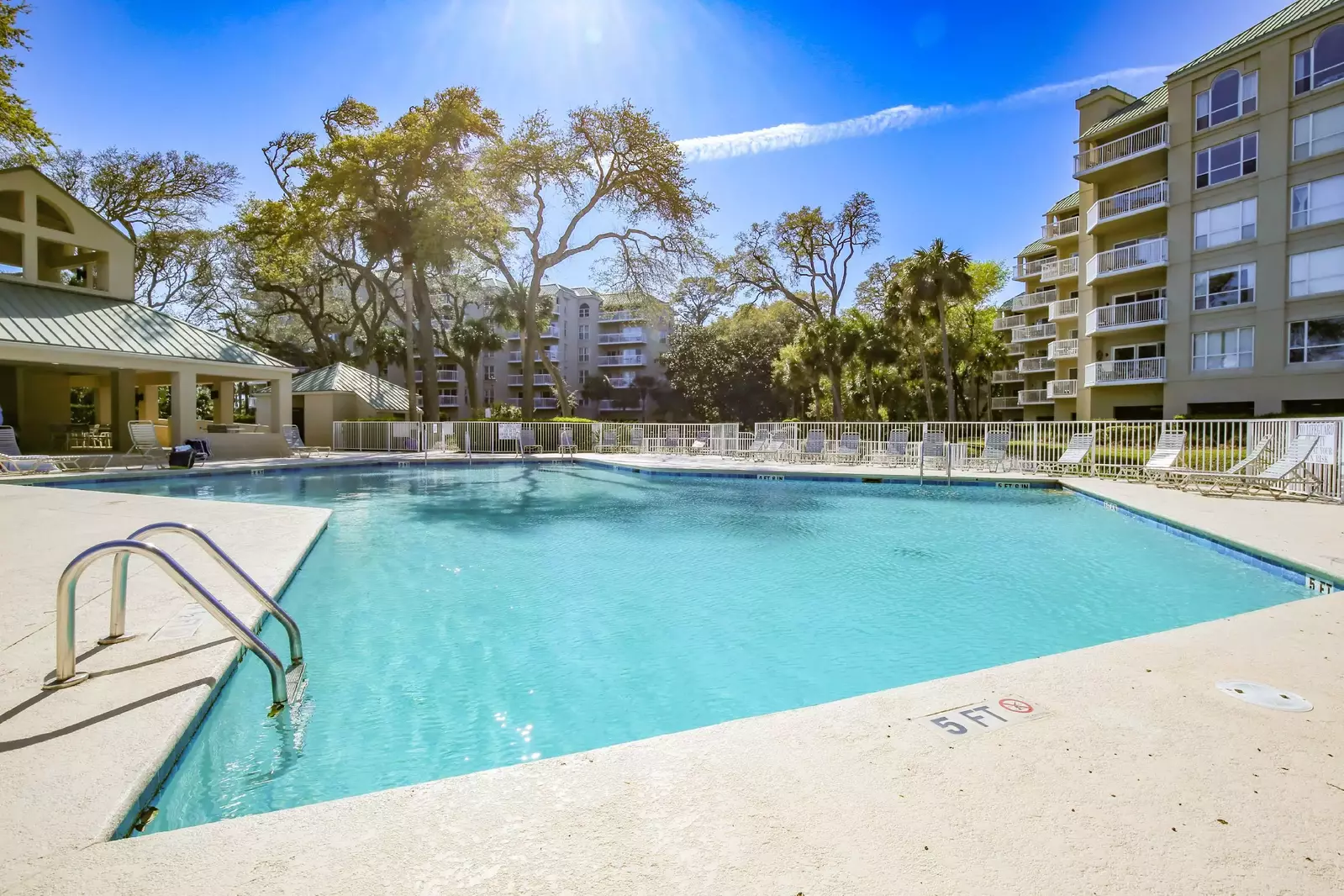 The Barrington community pool features a large sundeck with sun loungers.