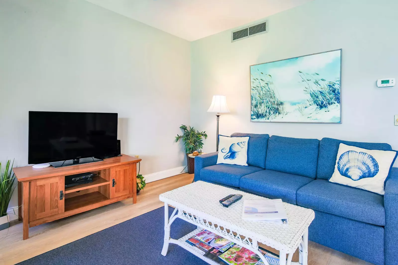 The sofa in the living room is a queen sleeper sofa.