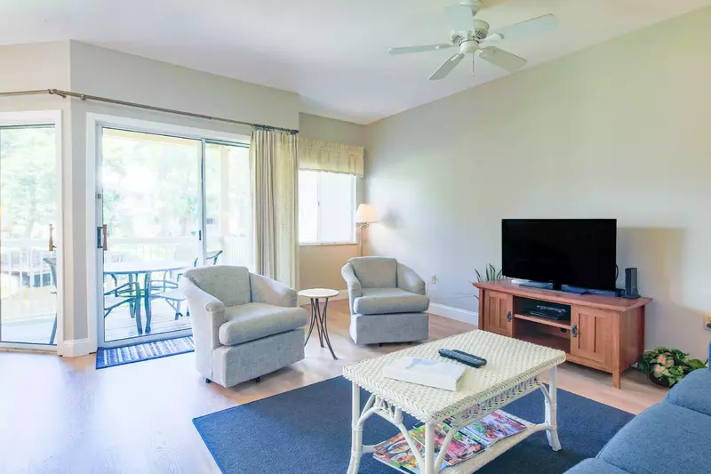 The living rooms receives wonderful natural light through the sliding glass doors.