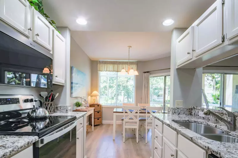 The dining area is located on the far side of the galley kitchen.