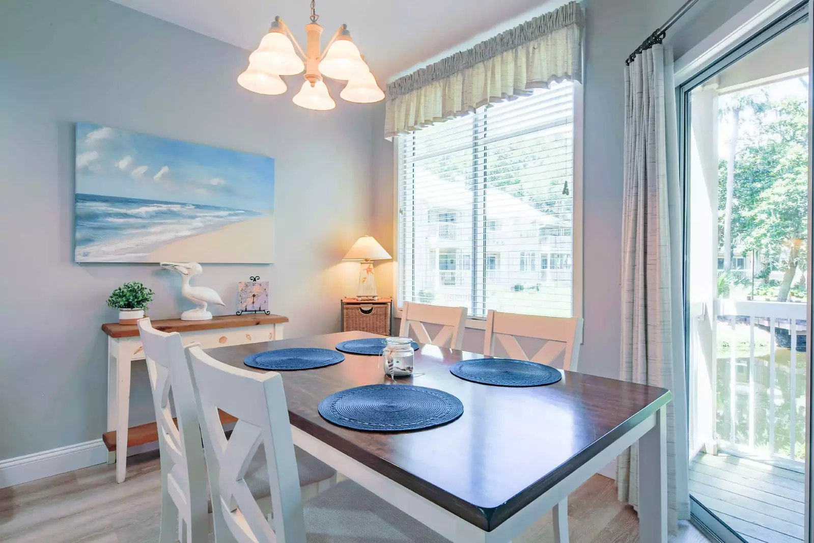 The dining table seats 4 and looks out onto the lagoon behind the condo.