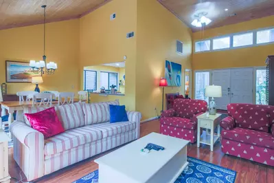 The living room features vaulted ceilings and a comfortable seating area.
