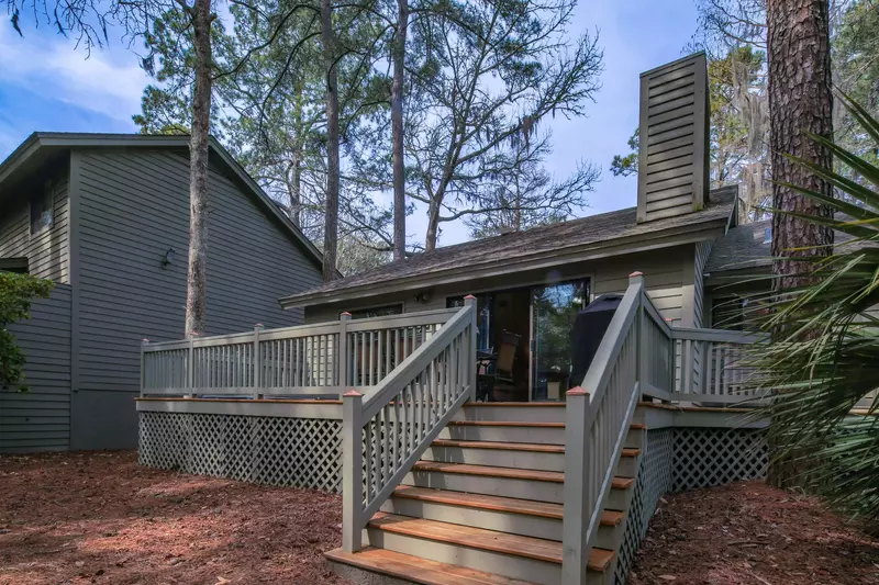 The house, which is surrounded by pine trees, saw palmetto shrubs & live oak trees, has a forest view