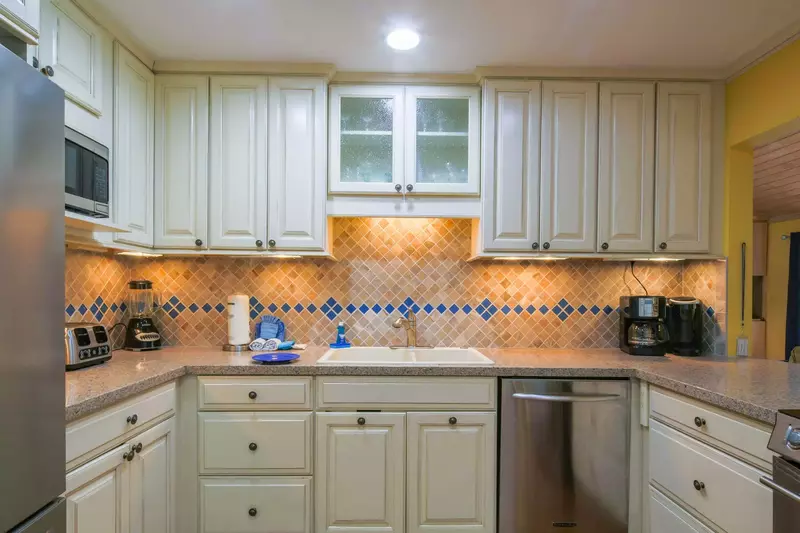 The kitchen features a refrigerator, dishwasher, microwave, range, coffee maker, blender and toaster.