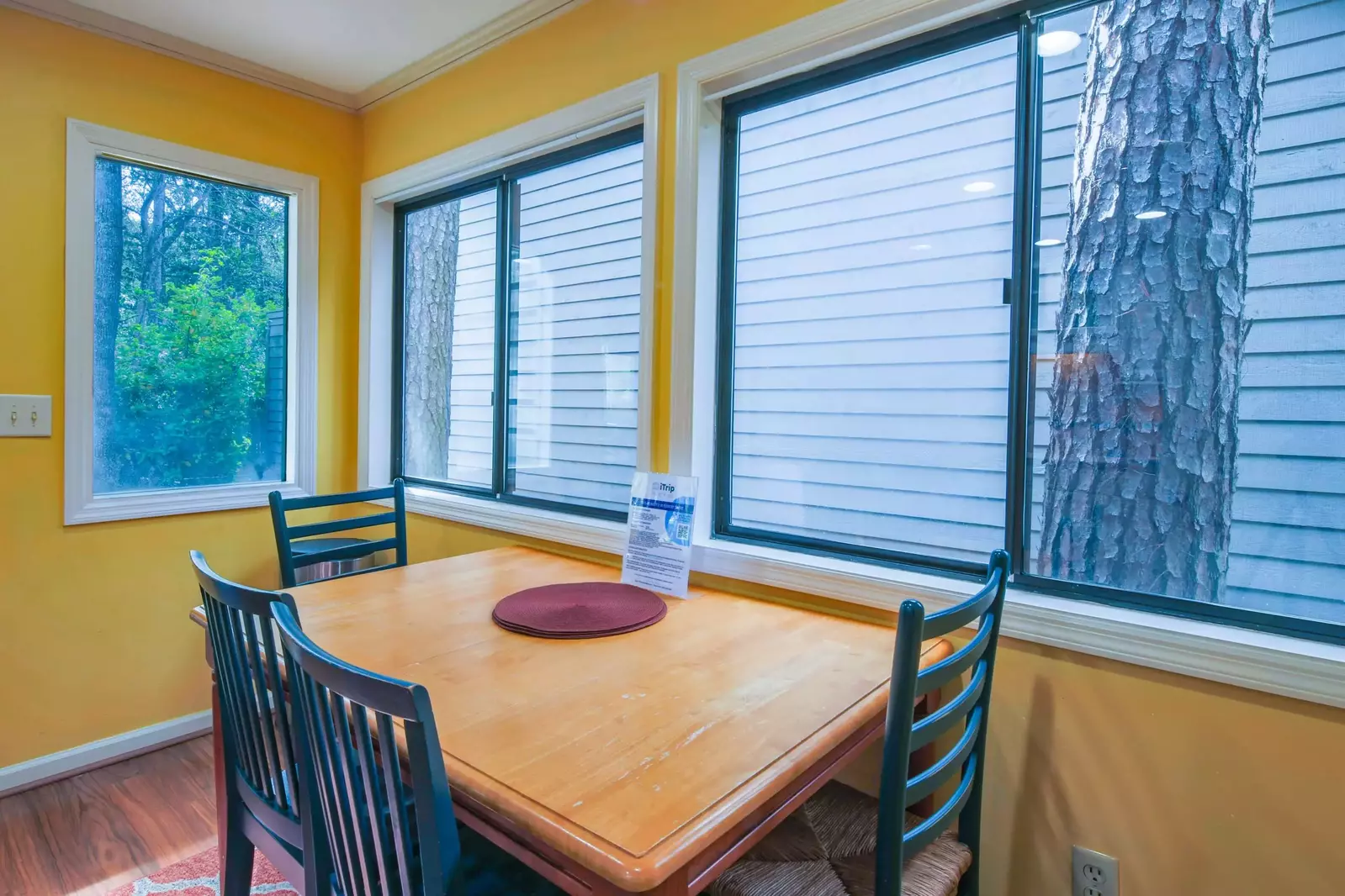 This dining table seats 4 and is located near the kitchen.